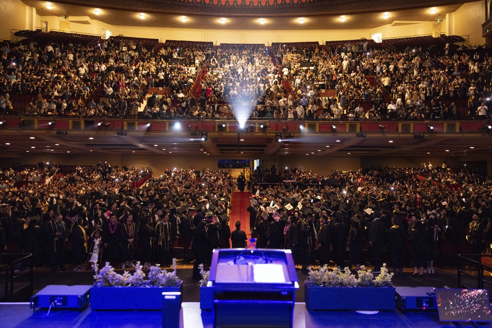 cal-state-la-2024-outstanding-professors View from the stage of a Cal State LA commencement ceremony, showing a packed auditorium with graduates and guests.